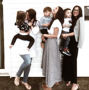 Joyful women and children family photo, celebrating love and connection in a backyard setting.