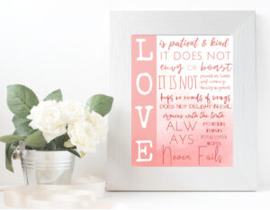 love is patient and kind wall art, pink ombre, in white frame with potted flowers
