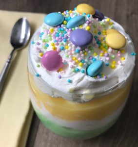 Close up trifle top spring M&Ms - If you are in need of an easy yet delicious Easter dessert, this trifle parfait is the perfect choice!&nbsp; With a wide choice of color and flavor combinations, you can create a no-fail spring dessert that quick fix for you and a mouthwatering treat for your guests!