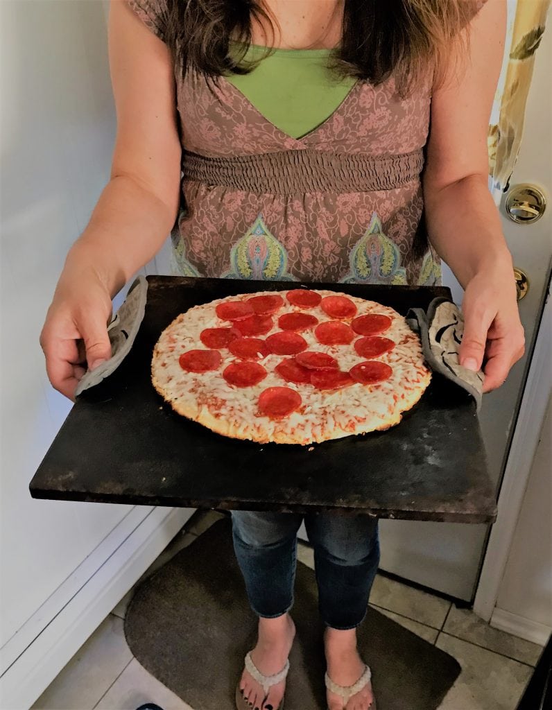 Fresh homemade pepperoni pizza on a baking sheet, ready to bake or serve, showcasing delicious comfort food for pizza lovers.
