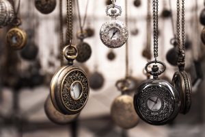 Vintage pocket watches and chains on display; timeless jewelry and accessories at A Hundred Affections.