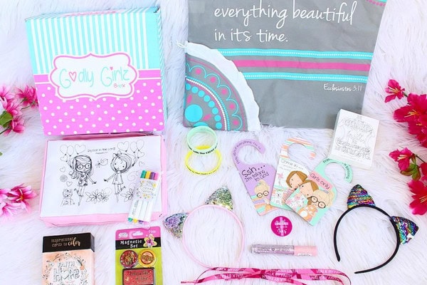Colorful girl's craft and activity pack with hair accessories, stickers, and coloring pages for kids.