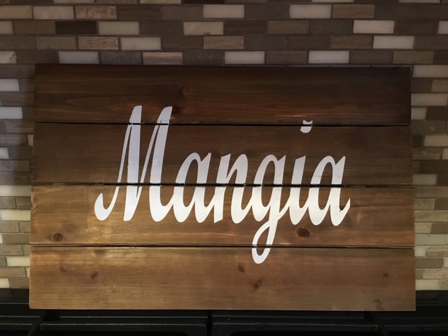 Handcrafted wooden "Mania" sign decor for stylish home or business interiors.