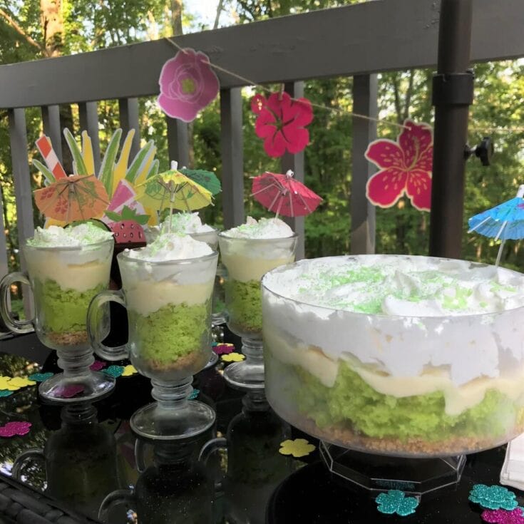 Colorful tropical-themed party drinks with mini umbrellas and decorative paper flowers, perfect for summer celebrations.