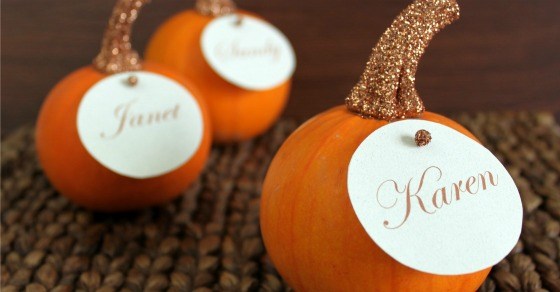 Cute personalized pumpkins with glitter stems and name tags, perfect for fall decor and autumn weddings.