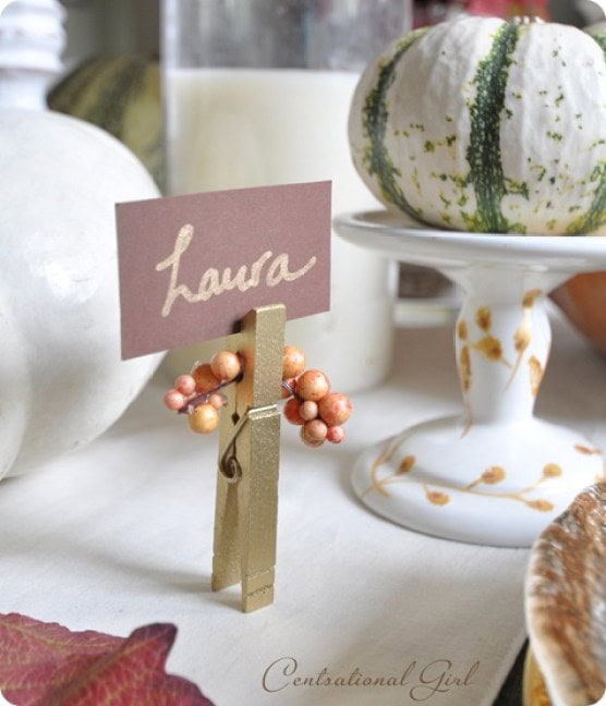 Personalized place card with "Laura" at an elegant fall table setting, featuring pumpkins and festive decor for autumn gatherings.