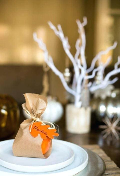 Festive gift bag with custom name tag, holiday decor, and elegant table setting at A Hundred Affections.