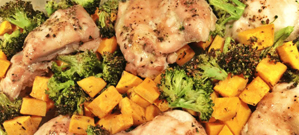 Roasted chicken with vibrant roasted vegetables including broccoli and sweet potatoes, healthy meal, nutritious dinner, wholesome food, and fresh ingredients.