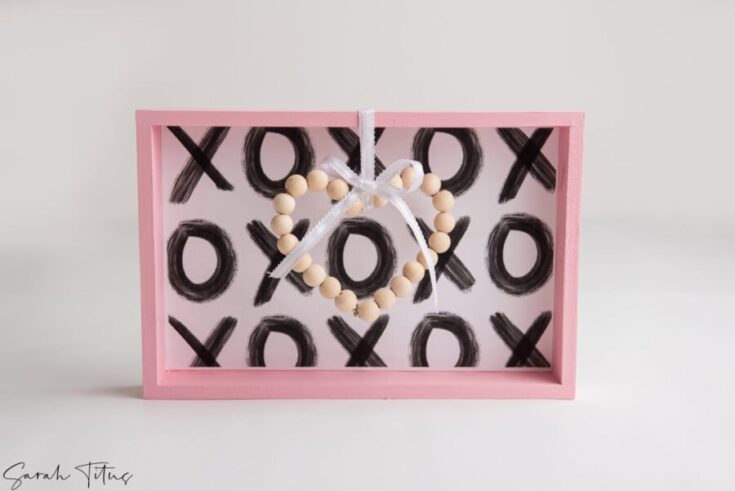 Decorative XO love frame with beaded heart, perfect for Valentine's Day or romantic gifts, handcrafted and stylish.
