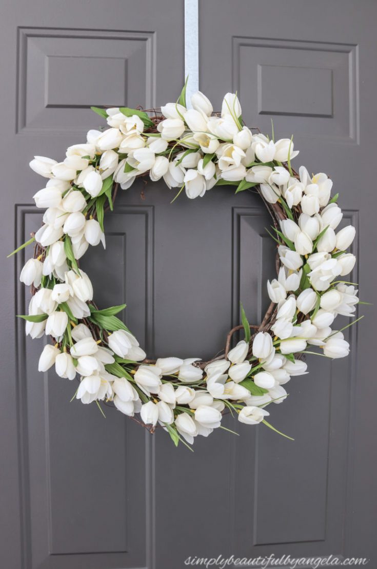 white tulip spring wreath on door.
