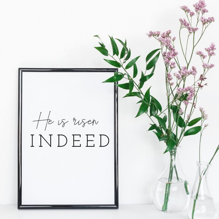 Gentle floral arrangement with pink statice flowers and green foliage in glass vases placed beside a black-framed quote print, minimalist home decor for inspiring spaces.