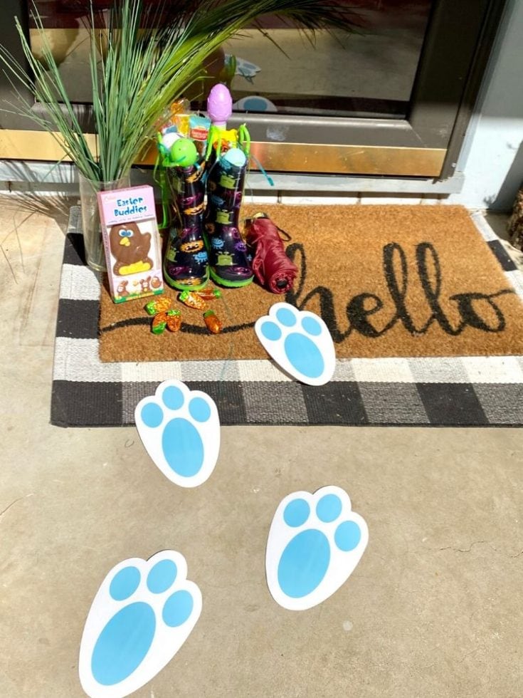 Colorful Easter basket with themed toys, rain boots, and paw print decals at the doorstep, celebrating spring and pet-friendly Home decor.