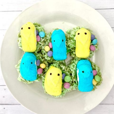 Colorful Peeps Easter treats with pastel candies on shredded lettuce, decorative and festive for spring celebrations.