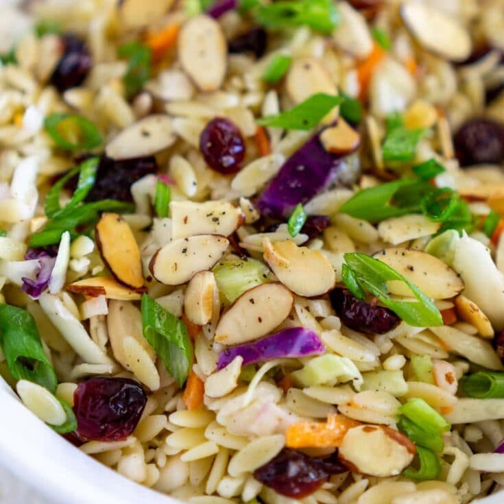 Fresh homemade nut and fruit salad with almonds, cranberries, and mixed greens, healthy and delicious snack.