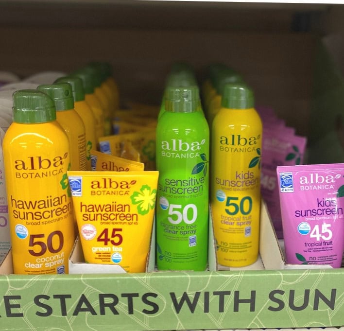 Alba botanica sunscreen variety display with Hawaiian, kids, and sensitive options, SPF 50 and 45, broad spectrum sun protection, natural ingredient skincare.