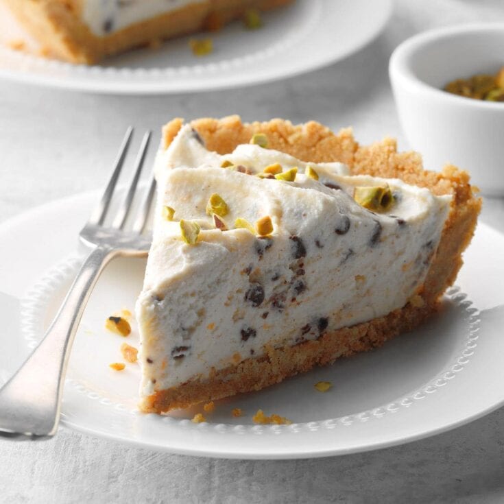 Rich and creamy no-bake pistachio cheesecake with chocolate chips and a crunchy graham cracker crust, perfect for decadent desserts and special occasions.