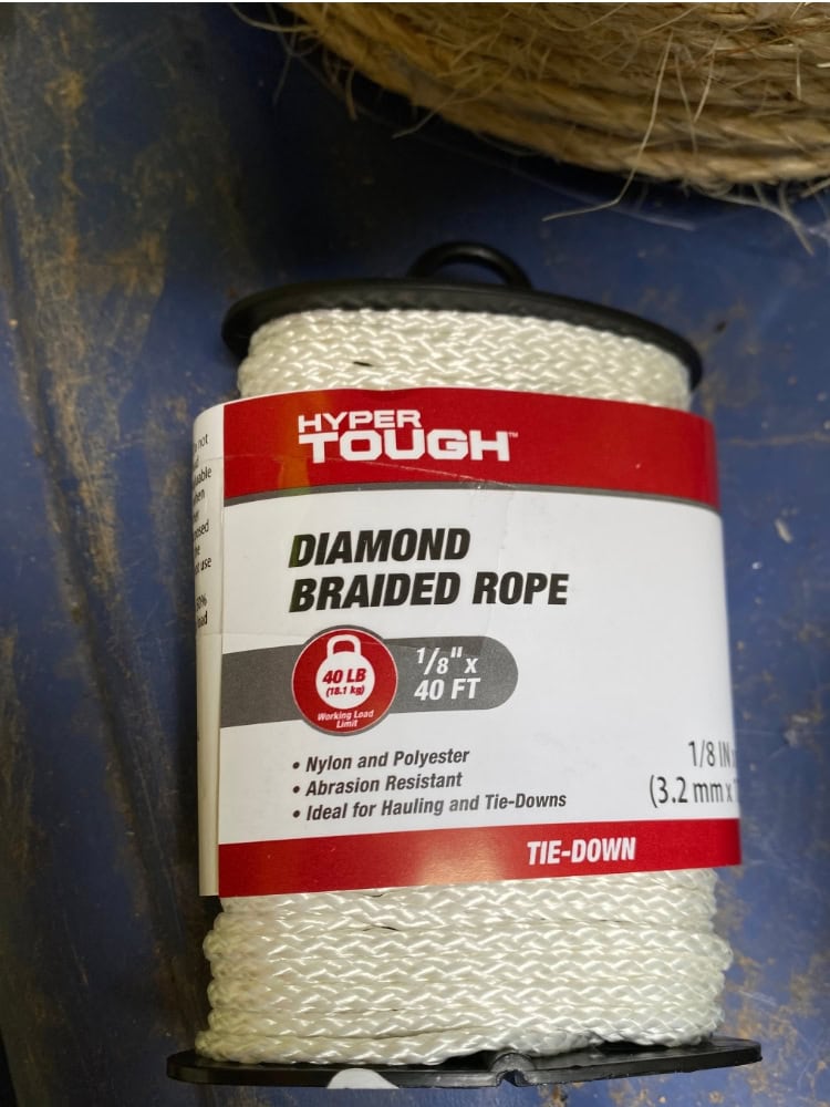 Diamond braided rope for tie-downs and hauling, strong nylon and polyester construction, abrasion resistant, 40 ft length, 1/8 inch diameter, ideal for heavy-duty outdoor and industrial use.