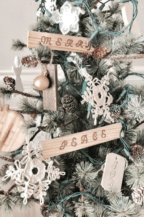 Rustic Christmas tree decorations with wooden tags and crochet snowflakes, ideal for holiday decor and winter-themed home accents.