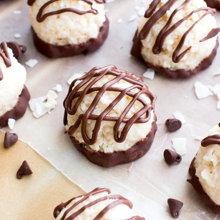 Decadent coconut macaroons dipped in chocolate and drizzled with additional chocolate, perfect for homemade treats and special occasions.
