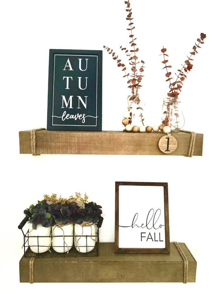Autumn decor with framed seasonal quotes, cozy fall-inspired vases, and rustic wooden shelves highlighting fall foliage and home accents.
