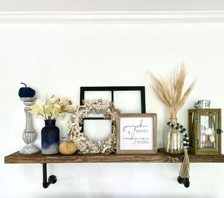 Pumpkin fall decor with dried flowers and rustic accents for cozy autumn ambiance.