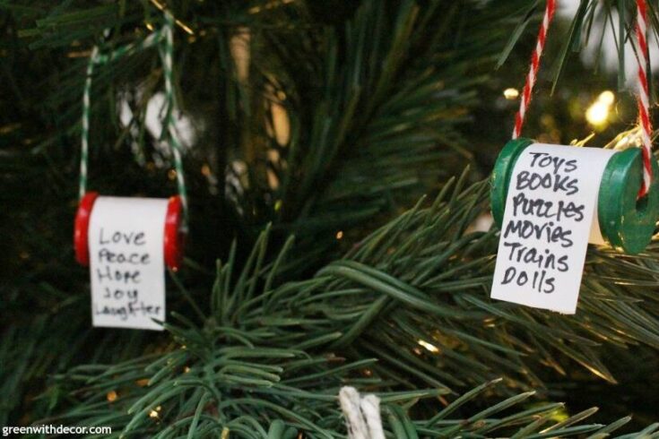 Love peace hope joy and laughter ornaments on a Christmas tree, handmade with painted cans and handwritten notes, representing heartfelt holiday wishes and family traditions.