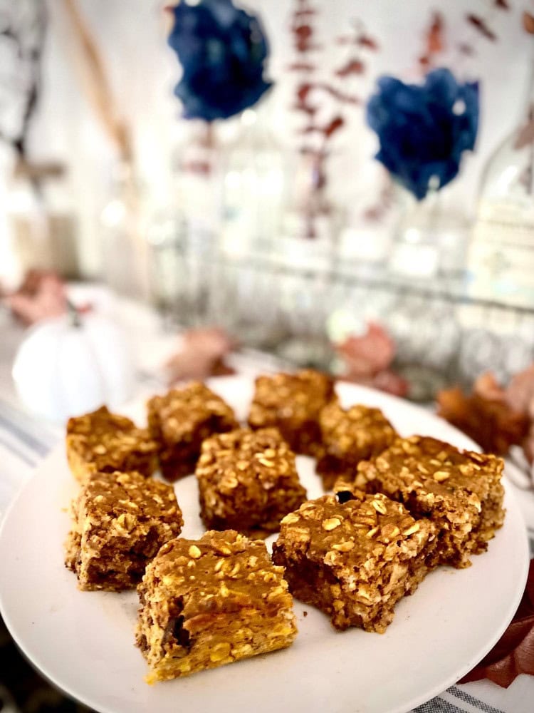 plated pumpkin oatmeal with flowers on table