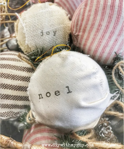 Soft Christmas ornaments with embroidered words "joy" and "noel" in neutral and pastel tones, perfect for holiday décor and gift-giving. Handcrafted fabric decorations add a cozy, festive touch to any home.