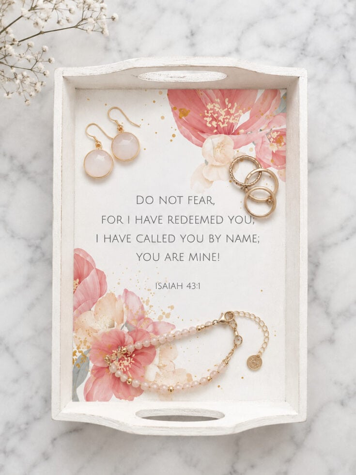 Jewelry display tray with earrings, bracelet, and a Bible verse from Isaiah 43:1, featuring pink floral accents for farmhouse decor.