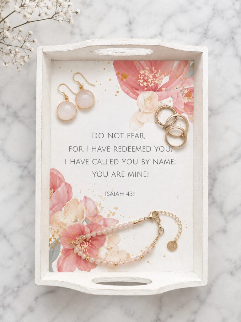 Jewelry display tray with earrings, bracelet, and a Bible verse from Isaiah 43:1, featuring pink floral accents for farmhouse decor.