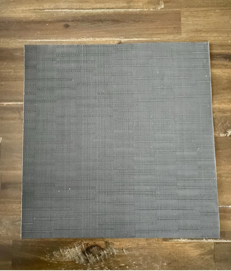 Dark gray textured placemat for dining table.