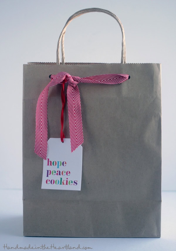 Hope peace cookies gift bag, handmade gift bag from A Hundred Affections, perfect for gifting handmade cookies and baked goods, with a pink and white ribbon, and a heartfelt tag for special occasions.