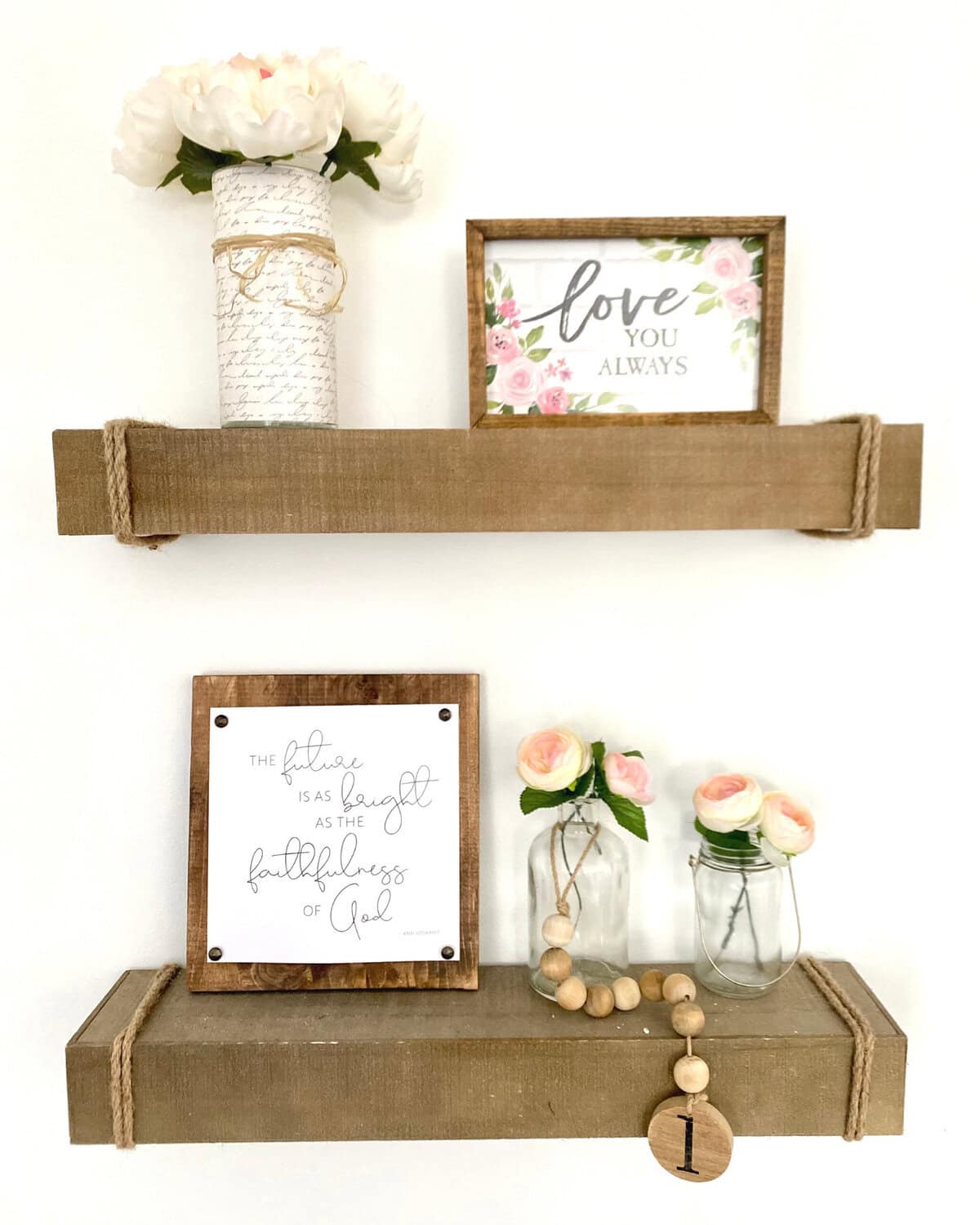 Delicate wall shelves with rustic wooden accents displaying romantic decor, floral arrangements, and inspirational quotes, perfect for cozy home decor or wedding decor ideas.