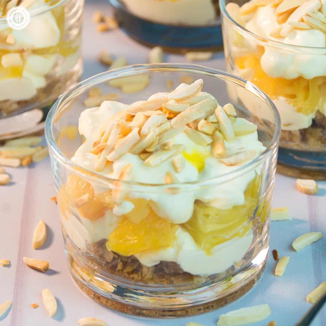 Creamy lemon pie parfait with whipped cream, toasted almonds, and fresh lemon slices in a glass. Perfect dessert for spring and summer gatherings.