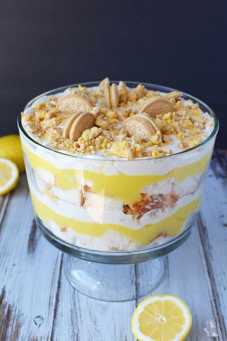 Delicious lemon cookies layered in a creamy dessert with lemon curd and crushed cookies, served in a glass bowl for a sweet and tangy treat perfect for summer gatherings.