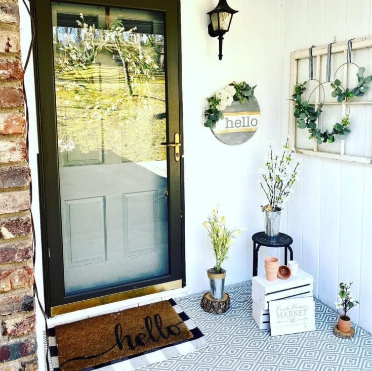 Hello spring floral arrangement welcoming front porch decor for spring and summer seasons.
