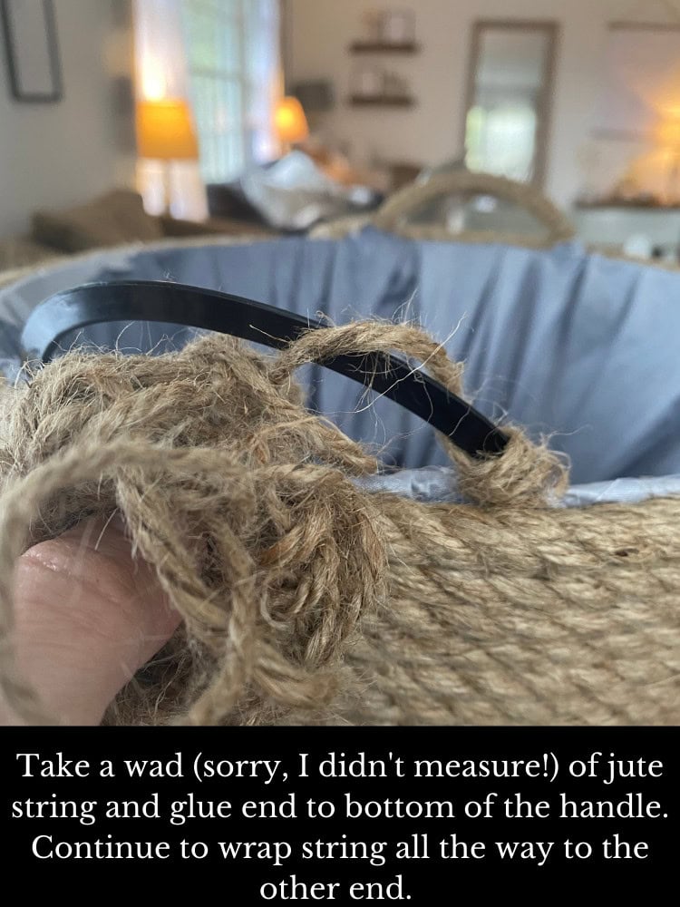 Black and beige jute basket handle with glued string, laid on a fabric-lined basket, cozy indoor background with soft lighting.