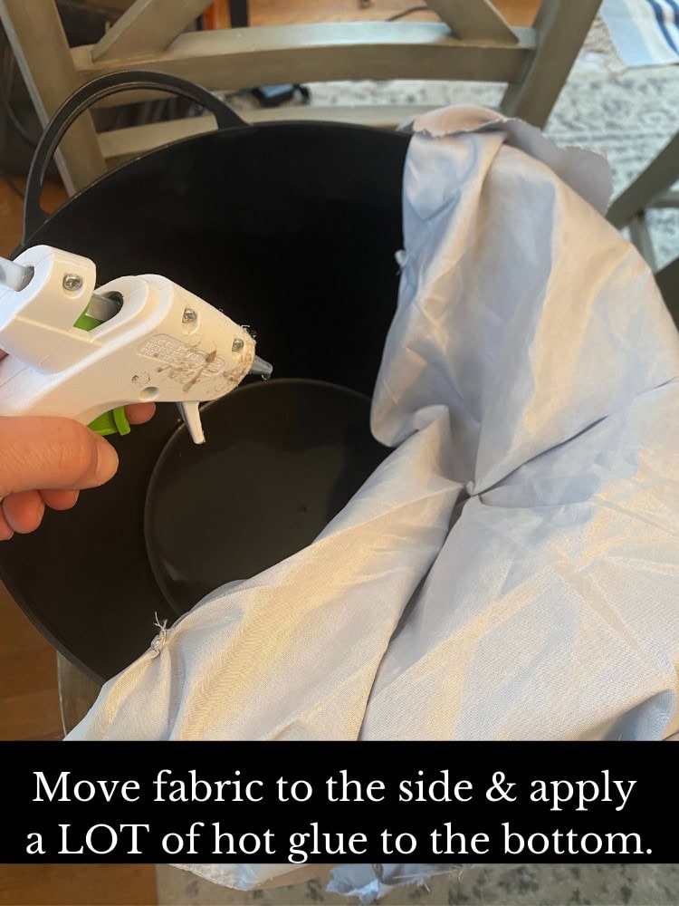 Hot glue gun being used to attach fabric to a container for craft project, diy home decor, sewing, fabric crafting, craft supplies, step-by-step tutorial, creative project, decorating ideas, craft tutorial, arts and crafts, craft DIY, craft techniques.