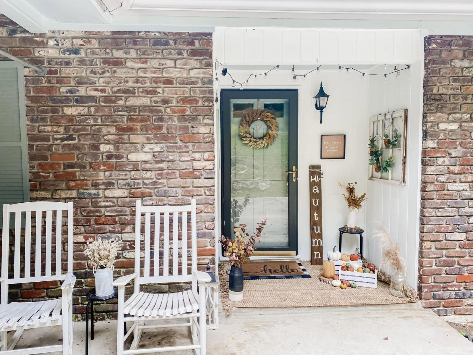 Autumn porch decor with fall-themed pumpkins, dried flowers, and cozy seasonal accents on a rustic farmhouse-style entryway.