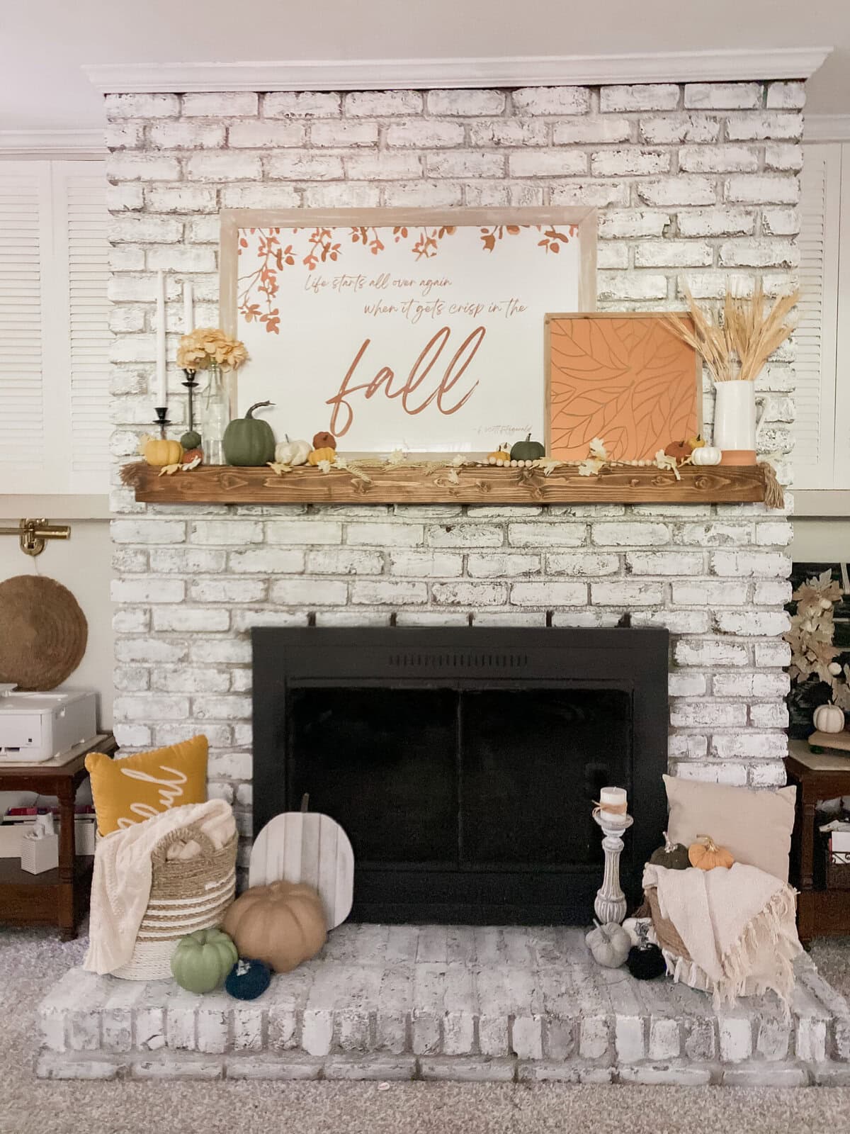 Cozy living room with brown leather sofa, rustic wooden accents, and decorative autumn-themed vases, creating a warm and inviting home interior atmosphere.