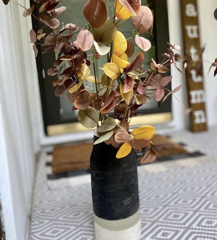 Delicate dried flower arrangements on rustic wooden shelves with inspirational quotes, creating a cozy and elegant home decor setup.