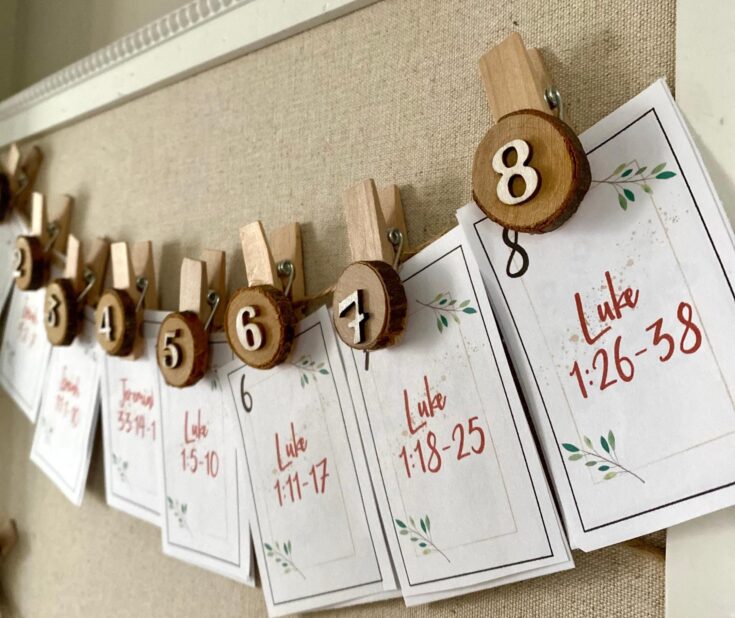 Clothesline with wooden clothespins holding wedding or event seating charts, numbered wooden slices, and printed paper cards with scripture references, elegant wedding decor, rustic wedding style, A Hundred Affections.