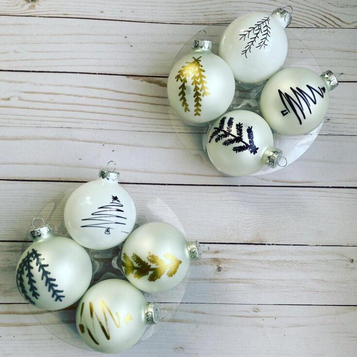 Hand-painted Christmas ornament balls with gold and black botanical and holiday designs, ideal for festive decorations and holiday cheer.