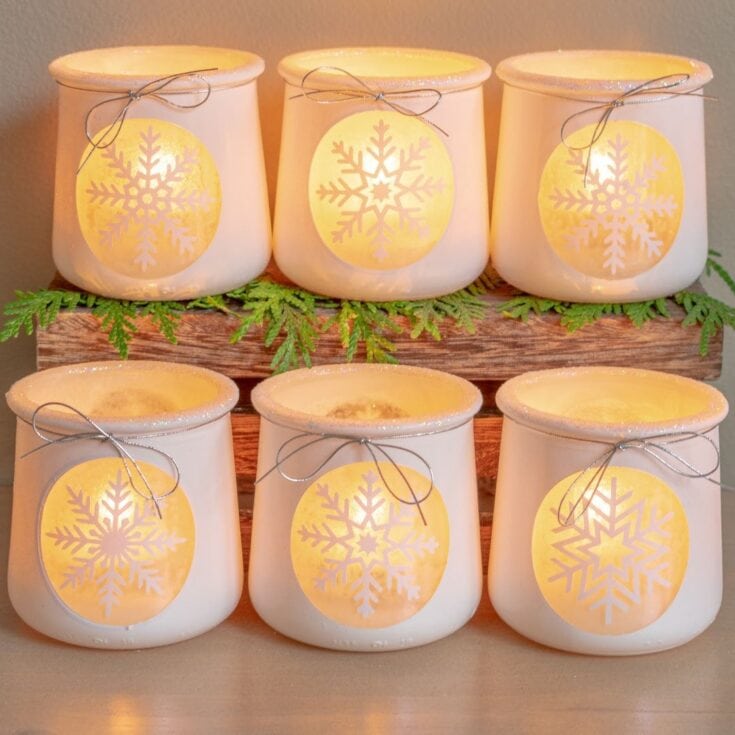 Flannel candle holders with snowflake designs, perfect for holiday decor, soft warm glow, festive winter ambiance, decorative candles, cozy Christmas centerpiece, handcrafted aesthetic, winter home decor, elegant and charming.