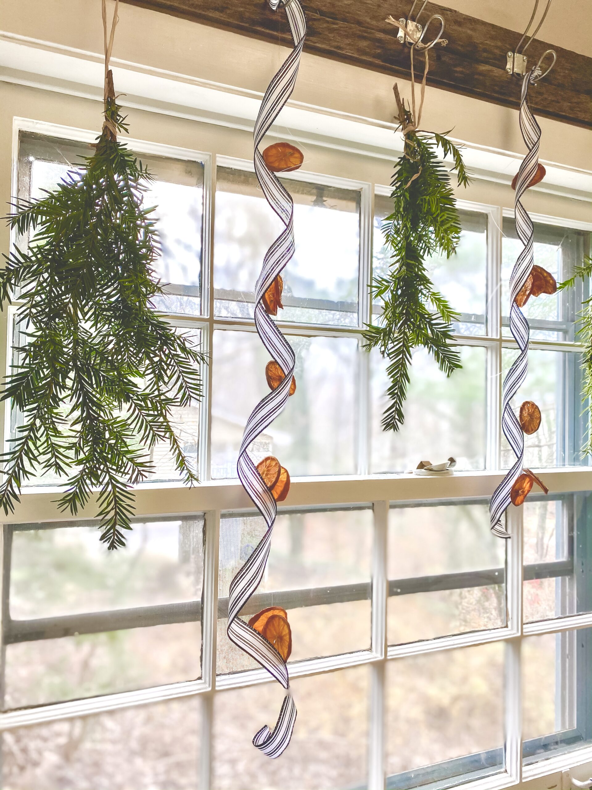 pine and orange and ribbon christmas window treatment