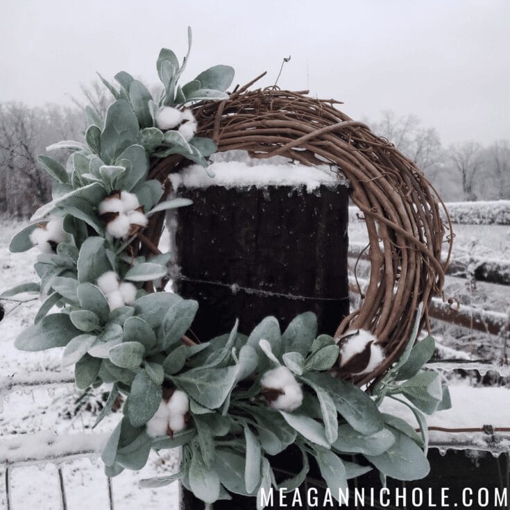 Votive candle holder with greenery and cotton accents in a snowy outdoor setting, evoking warmth and tranquility amidst winter charm. Ideal for rustic or holiday decor inspiration.