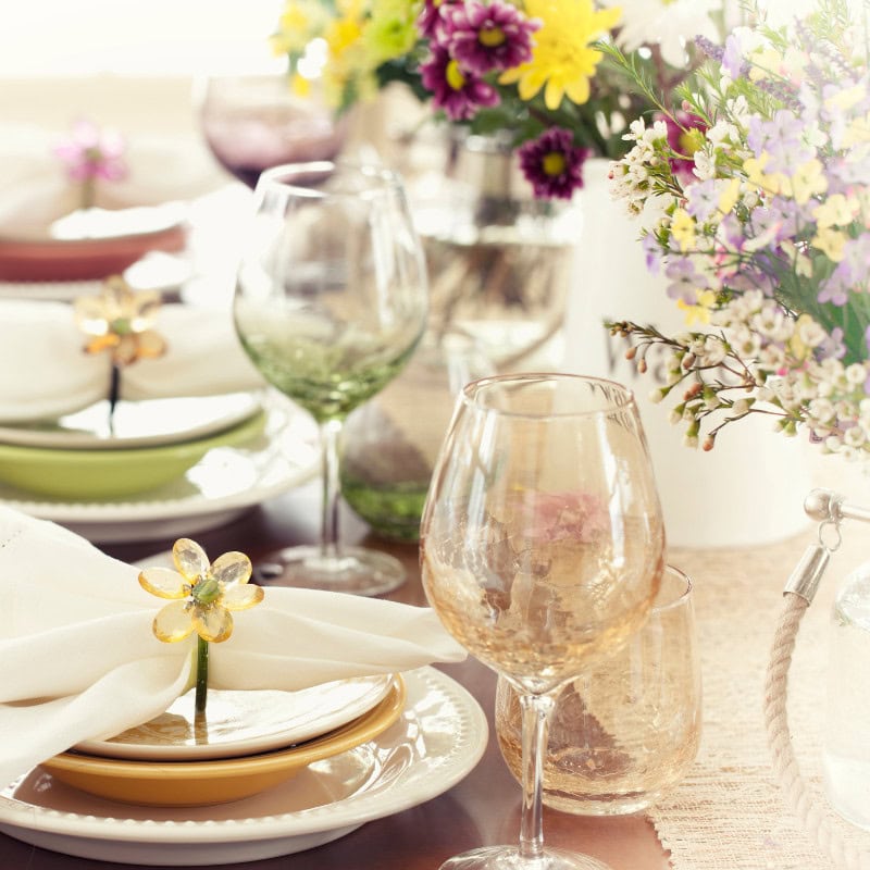Colorful floral table setting with elegant glassware and decorative accents for a special occasion or celebration at A Hundred Affections.