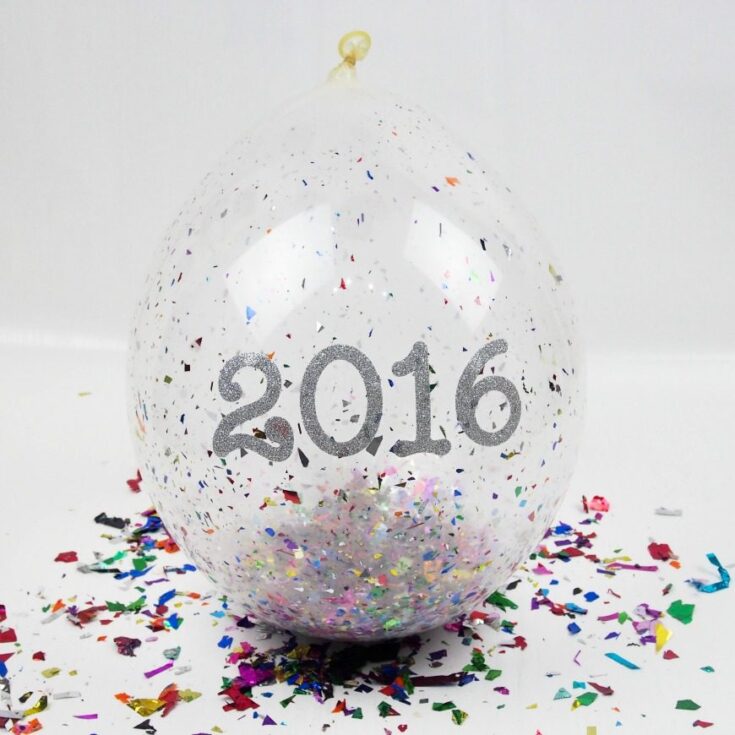 Balloon with glitter and confetti celebrating 2016 New Year, festive party decoration for New Year celebration, colorful confetti, transparent balloon, holiday event decoration.