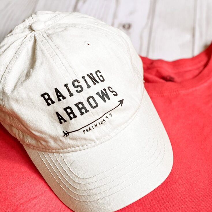 Raising Arrows baseball cap with biblical verse Psalm 125:4-5 on a pink shirt, Christian faith apparel, inspirational faith-based accessories, spiritual gifts, religious clothing, faith jewelry, Christian gifts.