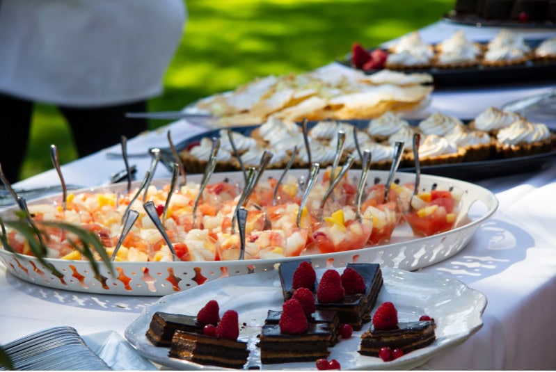 Delicious fruit and dessert platter at outdoor event, fresh strawberries and chocolates, elegant catering display, summer celebration food, A Hundred Affections event catering.
